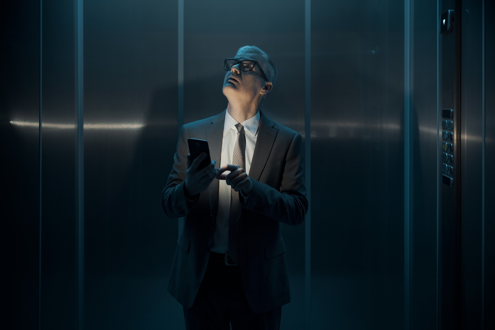 Worried Businessman Stuck In The Elevator Due To A Blackout
